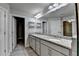 Bright bathroom featuring double vanity with granite countertops, modern fixtures, and walk-in closet at 4232 Perimeter E Park # 110, Atlanta, GA 30341