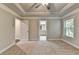 This bedroom features neutral carpet and paint with two windows and ensuite bathroom at 4232 Perimeter E Park # 110, Atlanta, GA 30341