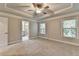 This bedroom features neutral carpet and paint with two windows and ensuite bathroom at 4232 Perimeter E Park # 110, Atlanta, GA 30341