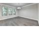 Dining area with hardwood floors, large windows, and modern lighting at 4232 Perimeter E Park # 110, Atlanta, GA 30341