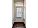 Inviting front door with sidelight and transom window, set against neutral walls and dark floors at 4232 Perimeter E Park # 110, Atlanta, GA 30341