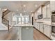 Open kitchen with a granite island, stainless appliances, and stairs to the second floor at 4232 Perimeter E Park # 110, Atlanta, GA 30341