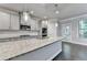 Open kitchen features a granite island, stainless appliances, and a view to the backyard at 4232 Perimeter E Park # 110, Atlanta, GA 30341