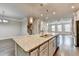 Open kitchen features a granite island with a sink, stainless appliances, and flows into the living area at 4232 Perimeter E Park # 110, Atlanta, GA 30341