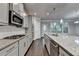 Beautiful kitchen with stainless appliances, granite countertops, gray cabinets, and hardwood floors at 4232 Perimeter E Park # 110, Atlanta, GA 30341