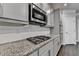 Well-appointed kitchen with granite countertops, stainless steel appliances, and gray cabinets at 4232 Perimeter E Park # 110, Atlanta, GA 30341