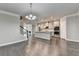 Open-concept living space with hardwood floors, a fireplace, a kitchen, and a staircase at 4232 Perimeter E Park # 110, Atlanta, GA 30341