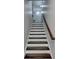 Staircase with dark wood treads, white risers, and wooden handrail, leading to upper level at 4232 Perimeter E Park # 110, Atlanta, GA 30341