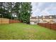 Expansive backyard featuring a well-maintained lawn and a privacy fence at 5567 Executive Way, Norcross, GA 30071