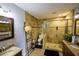 Tiled bathroom with glass shower, toilet, and granite top double vanity sinks at 5567 Executive Way, Norcross, GA 30071