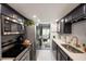 Modern kitchen boasts stainless steel appliances, white subway tile backsplash and dark cabinetry at 5567 Executive Way, Norcross, GA 30071