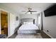 Inviting main bedroom with large bed, ceiling fan, mounted flat screen television and ensuite bathroom access at 5567 Executive Way, Norcross, GA 30071