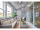 Bright sunroom with tiled floors, large windows, and a comfortable seating area at 5567 Executive Way, Norcross, GA 30071