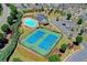 Aerial view featuring a swimming pool and tennis courts surrounded by beautiful landscaping and community amenities at 68 Hardy Water Dr, Lawrenceville, GA 30045