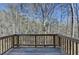 A wooden deck overlooking a lush, wooded area, perfect for enjoying nature and outdoor living at 68 Hardy Water Dr, Lawrenceville, GA 30045