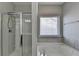 A bathroom showcasing a shower, tub, and window offering a luxurious bathing experience with natural light at 68 Hardy Water Dr, Lawrenceville, GA 30045