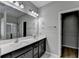 A bathroom featuring double sinks and a glass enclosed shower showcasing modern amenities and ample space at 68 Hardy Water Dr, Lawrenceville, GA 30045
