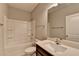 Bathroom with white vanity, shower-tub and a large mirror at 68 Hardy Water Dr, Lawrenceville, GA 30045
