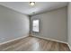 Neutral bedroom with a window and light vinyl floors at 68 Hardy Water Dr, Lawrenceville, GA 30045
