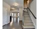 Inviting entryway featuring hardwood floors, staircase, and open view to kitchen and living space at 68 Hardy Water Dr, Lawrenceville, GA 30045