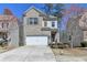 Charming two-story home with a well-manicured lawn and attached two-car garage at 68 Hardy Water Dr, Lawrenceville, GA 30045