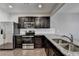 Well-equipped kitchen with granite countertops, stainless appliances, and dark wood cabinetry at 68 Hardy Water Dr, Lawrenceville, GA 30045