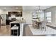 Open concept kitchen with stainless steel appliances and dining area with lots of natural light at 68 Hardy Water Dr, Lawrenceville, GA 30045
