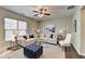 Comfortable living room with large windows, neutral decor, and ample seating at 68 Hardy Water Dr, Lawrenceville, GA 30045