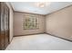 Serene bedroom with carpet, a modern light fixture, a window, and closet doors, providing a clean, quiet space at 929 Hampton Nw Trl, Lilburn, GA 30047