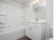 Bathroom features a tub-shower, white vanity and modern fixtures at 1704 Evenstad Way, Smyrna, GA 30080