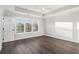 Bedroom features a tray ceiling, large window, and wood-look flooring at 1704 Evenstad Way, Smyrna, GA 30080