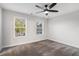 Bright, carpeted bedroom featuring a ceiling fan and two windows that let in plenty of natural light at 1704 Evenstad Way, Smyrna, GA 30080