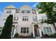 Beautiful townhome featuring a brick facade, gray shutters, and a well-maintained front yard at 1704 Evenstad Way, Smyrna, GA 30080