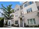 Front view of townhomes featuring a brick facade, windows, and manicured landscaping at 1704 Evenstad Way, Smyrna, GA 30080