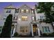 Townhome exterior view shows brick facade and gray shutters, softly lit in the evening at 1704 Evenstad Way, Smyrna, GA 30080