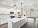 Bright kitchen with white cabinets, quartz countertops, stainless steel appliances, and pendant lighting at 1704 Evenstad Way, Smyrna, GA 30080