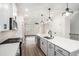 Open kitchen featuring a large island, modern lighting, and a view into the living area at 1704 Evenstad Way, Smyrna, GA 30080