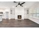 Spacious living room with built-in shelving, fireplace, and modern kitchen in the background at 1704 Evenstad Way, Smyrna, GA 30080
