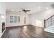 Sunlit living room with hardwood floors, fireplace, and staircase with black metal balusters at 1704 Evenstad Way, Smyrna, GA 30080