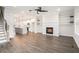 Open-concept living space with fireplace, built-in shelves, modern lighting, and wood flooring at 1704 Evenstad Way, Smyrna, GA 30080