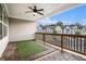 Covered porch features wood deck tiles, an artificial lawn, a ceiling fan, and a wood railing, perfect for outdoor enjoyment at 1704 Evenstad Way, Smyrna, GA 30080