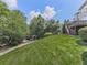 Expansive backyard with a level lawn, wooded area, gazebo, play set and a spacious home in the distance at 310 River Birch Ct, Canton, GA 30114