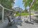 Picturesque backyard oasis featuring a stone patio with seating, lush lawn, and mature trees for shade at 310 River Birch Ct, Canton, GA 30114