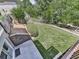 Beautifully landscaped backyard featuring a manicured lawn, lush greenery, and a charming wooden fence at 310 River Birch Ct, Canton, GA 30114