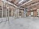 An unfinished basement presents stud framed walls, ceiling insulation, and concrete floor for personalization at 310 River Birch Ct, Canton, GA 30114