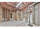 An unfinished basement displays stud framed walls and ceiling insulation awaiting personalization at 310 River Birch Ct, Canton, GA 30114