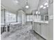 A full bathroom featuring a separate shower, soaking tub, and double sink vanity with generous lighting at 310 River Birch Ct, Canton, GA 30114
