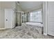 A full bathroom with a separate shower and soaking tub, plus a framed window for natural light at 310 River Birch Ct, Canton, GA 30114