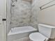 Bathroom shower and toilet area with neutral tiling and silver fixtures at 310 River Birch Ct, Canton, GA 30114