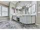 A full bathroom featuring a double sink vanity, tile floor, and a framed window for natural light at 310 River Birch Ct, Canton, GA 30114